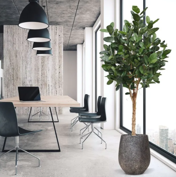 Moderne werkruimte met kunstplanten die zorgen voor een nette, duurzame en uitnodigende kantooromgeving.